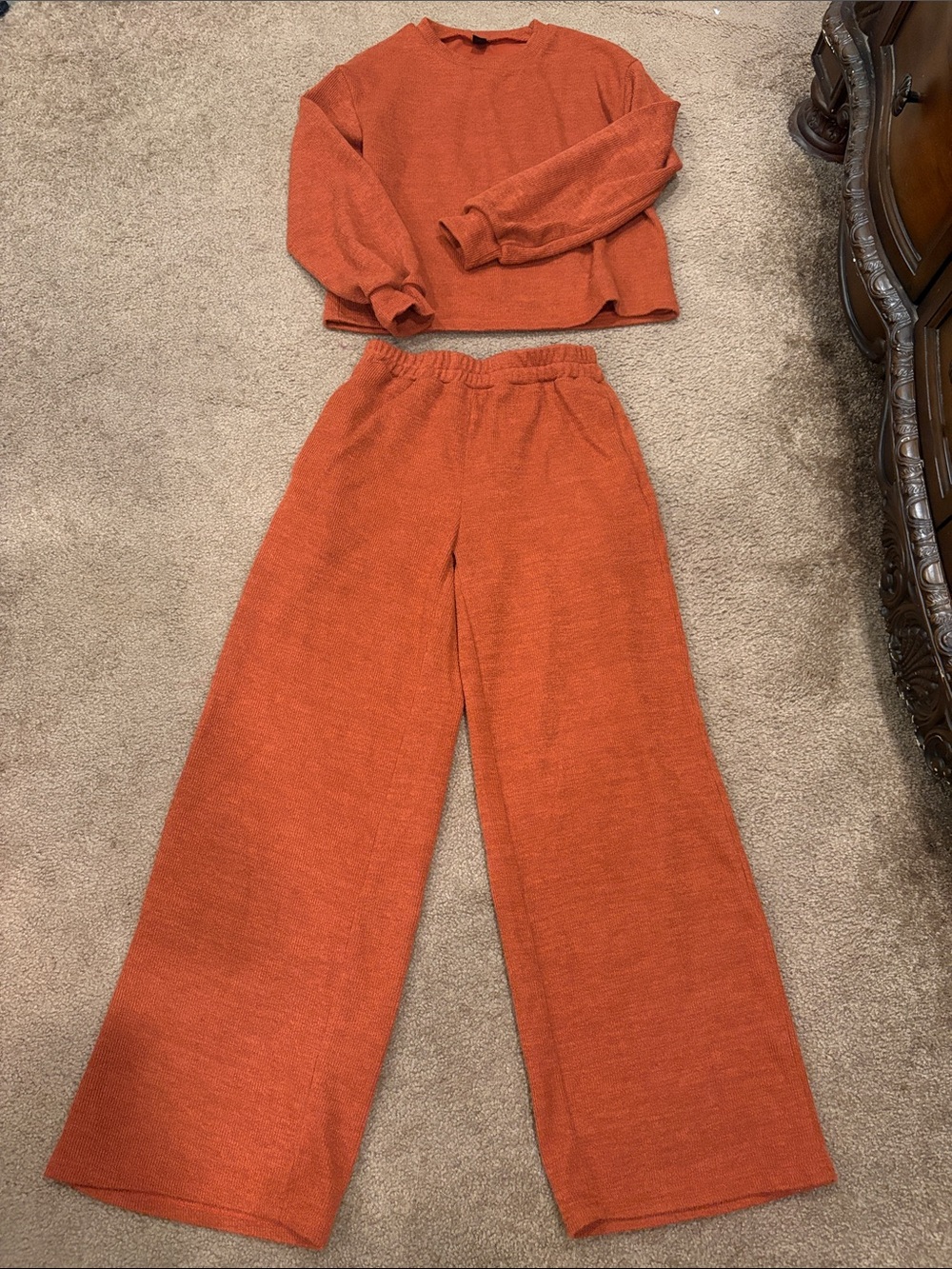Matching two-piece lounge set burnt orange/rust crewneck wide leg bottoms